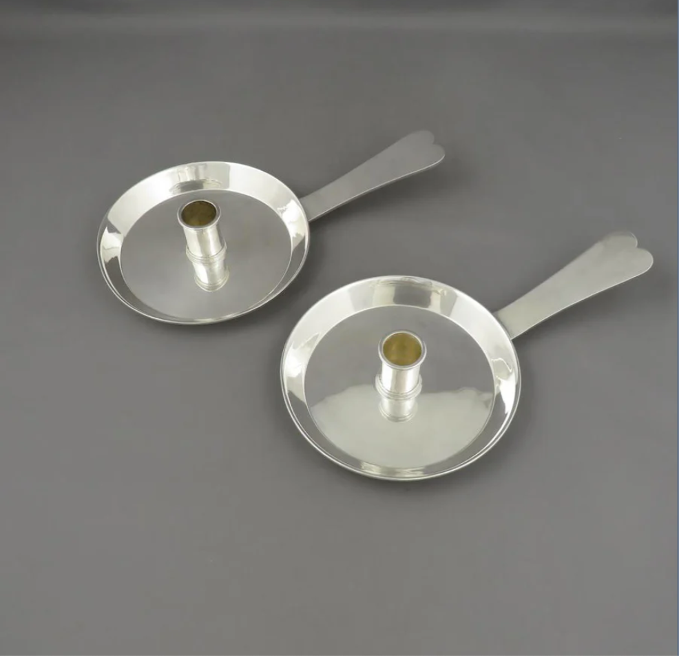 A fine pair of Edwardian sterling chambersticks by Selfridge & Co, London 1901