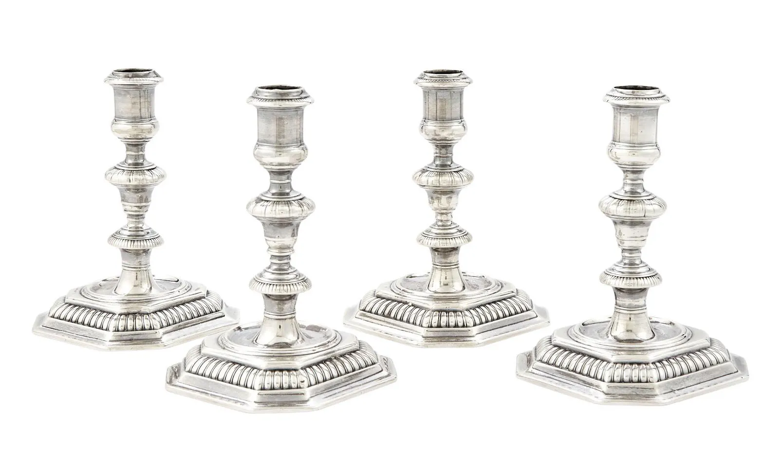 A very rare 17th C set of four William III cast silver candlesticks, London 1695