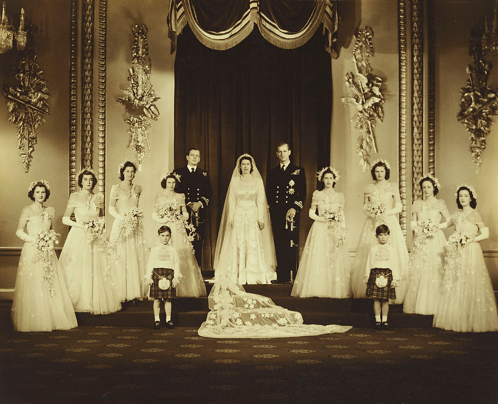 Full length formal group wedding portrait with Princess Elizabeth and Prince Philip standing in the centre flanked by Lord Milford Haven (1919-70) and bridesmaids, as well as by the young Prince William of Gloucester (1941-72) and Prince Michael of Kent (b. 1942). Photograph taken in the Throne Room at Buckingham Palace.