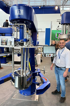 Our director Paul standing next to a Niemann machine at the european coatings show