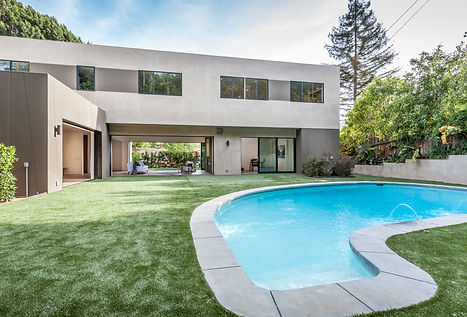Modern backyard with curved swimming pool and indoor outdoor architecture by NYC interior designer in Los Angeles home