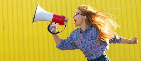 woman yelling into a bullhorn