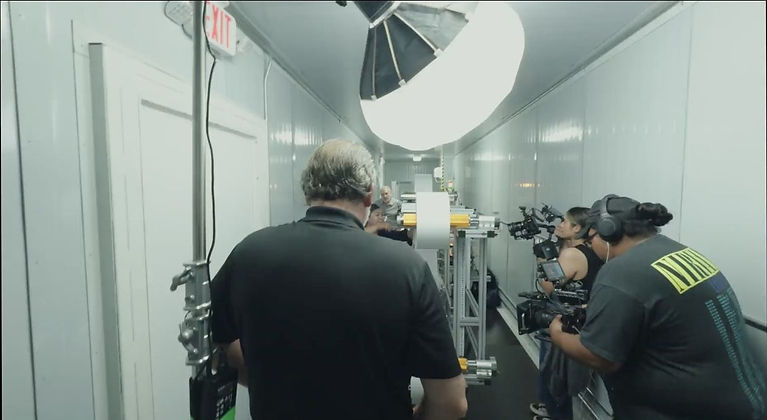 Royal Elect Studios camera crew filming the AFFOA RACER manufacturing project inside an industrial facility in El Paso, Texas