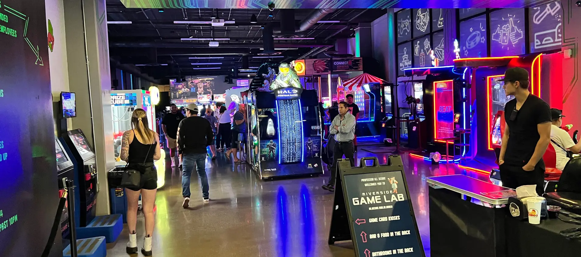 a look at the arcade bar with people walking through it