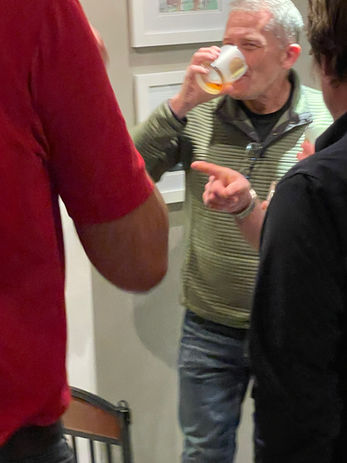 Man enjoying whiskey, art gallery
