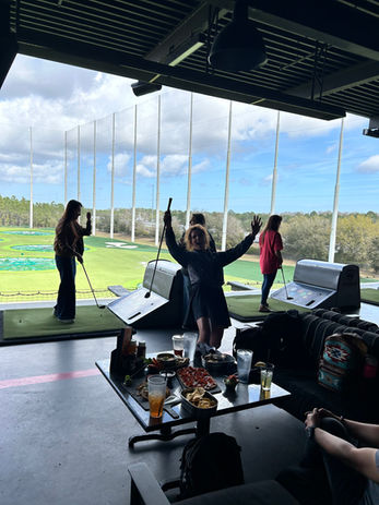 Golfer celebrating at Topgolf driving range