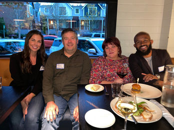 Four colleagues enjoy dinner together