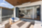 Modern patio with fire pit and retractable glass doors