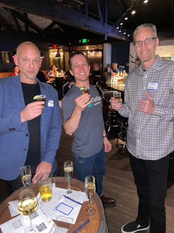 Three men enjoying drinks at a bar