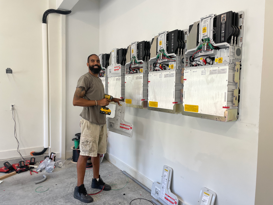 Newport Solar technician installing batteries