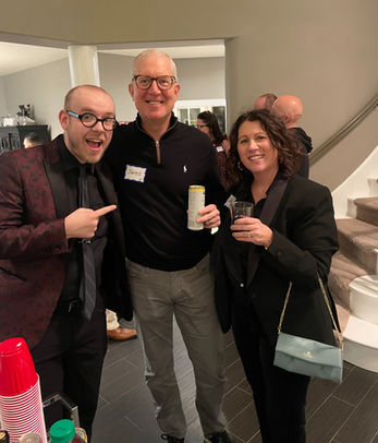 Three colleagues smiling for a photo at an event