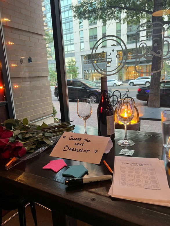 Table with wine, roses, candle, 'Thank You For Coming!' card