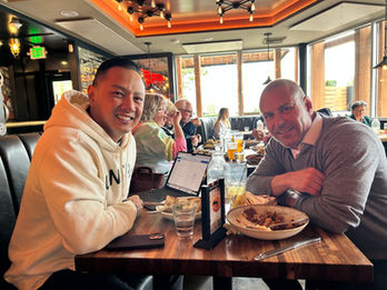 Two men smiling at restaurant table