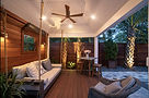 Modern covered patio with swinging sofa and ceiling fan.