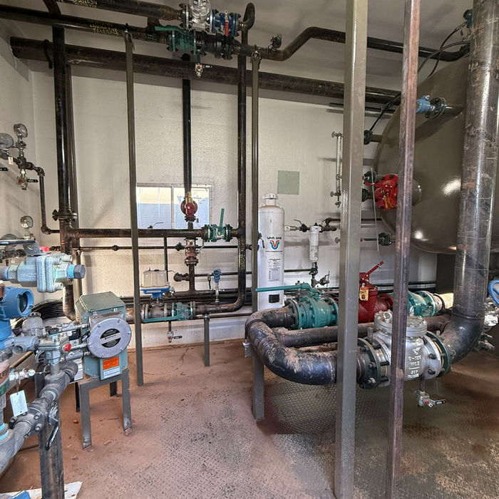 Industrial facility interior with pipes and equipment