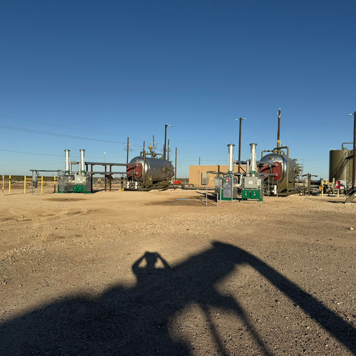 Industrial facility: large tanks and equipment under a clear sky