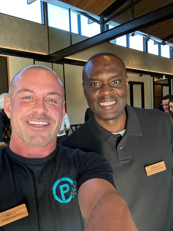 Two smiling men at an event