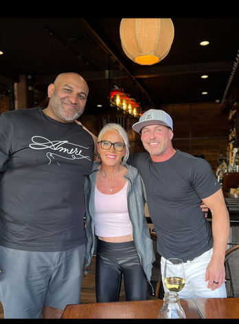 Three smiling people pose for a photo together