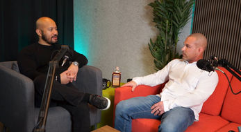 Two men in conversation during podcast recording