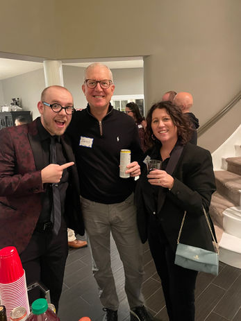Three colleagues smiling at a corporate event
