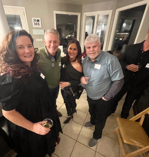 Group of friends pose for a photo at a social gathering.