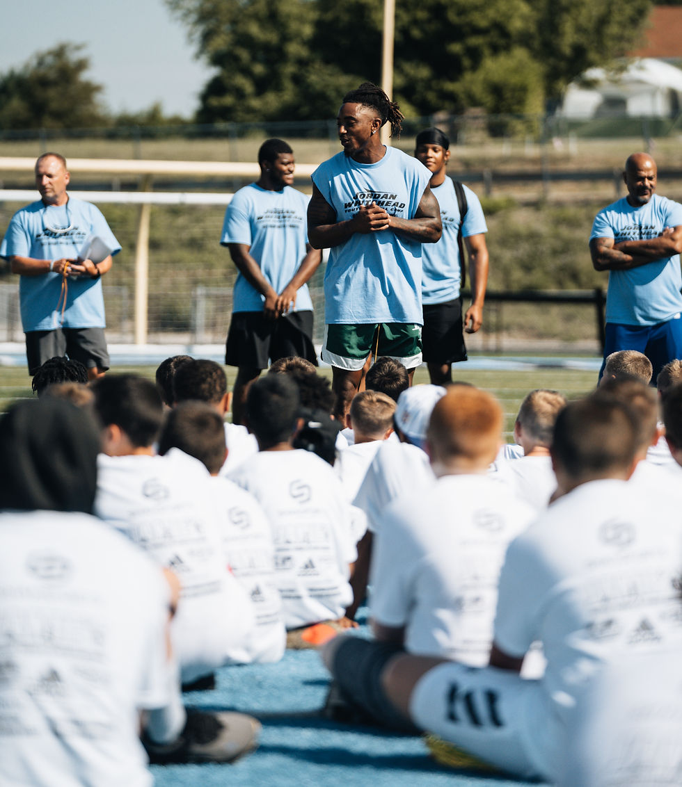 Coach addressing youth athletes during outdoor session