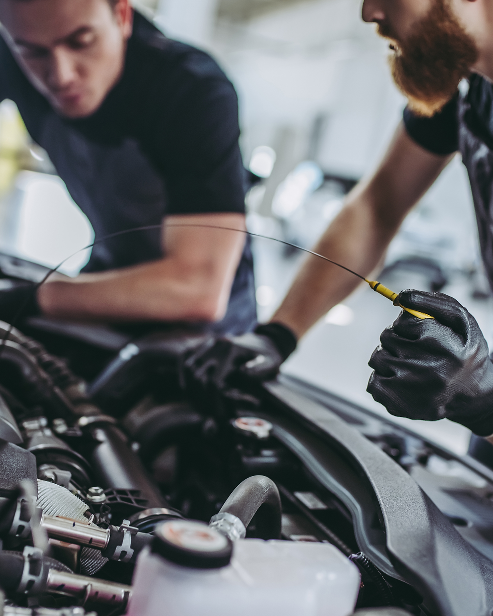 Men working in car's machine