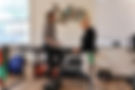 Woman performs balance exercise with physical therapist