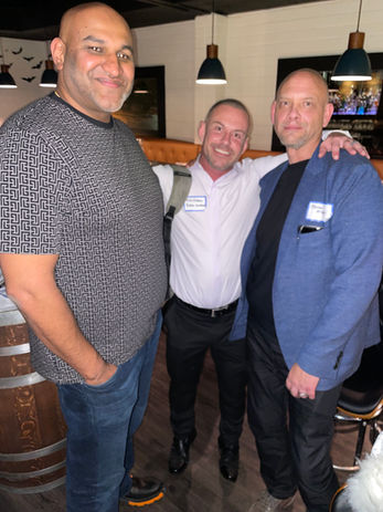 Three men smiling for a photo
