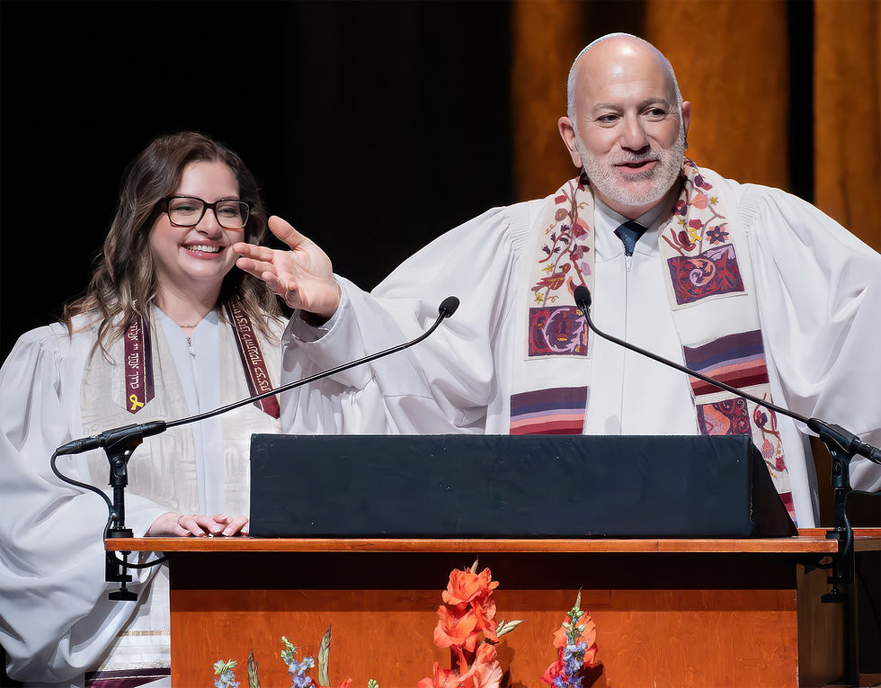 A rabbi and cantor leading a service from a podium