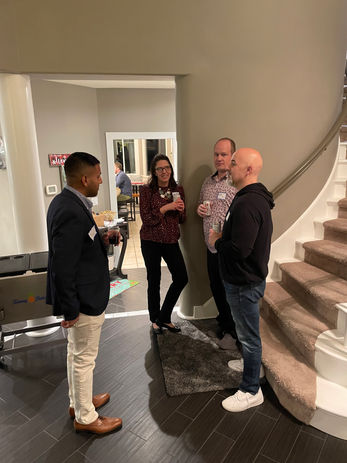 Four colleagues networking at an event