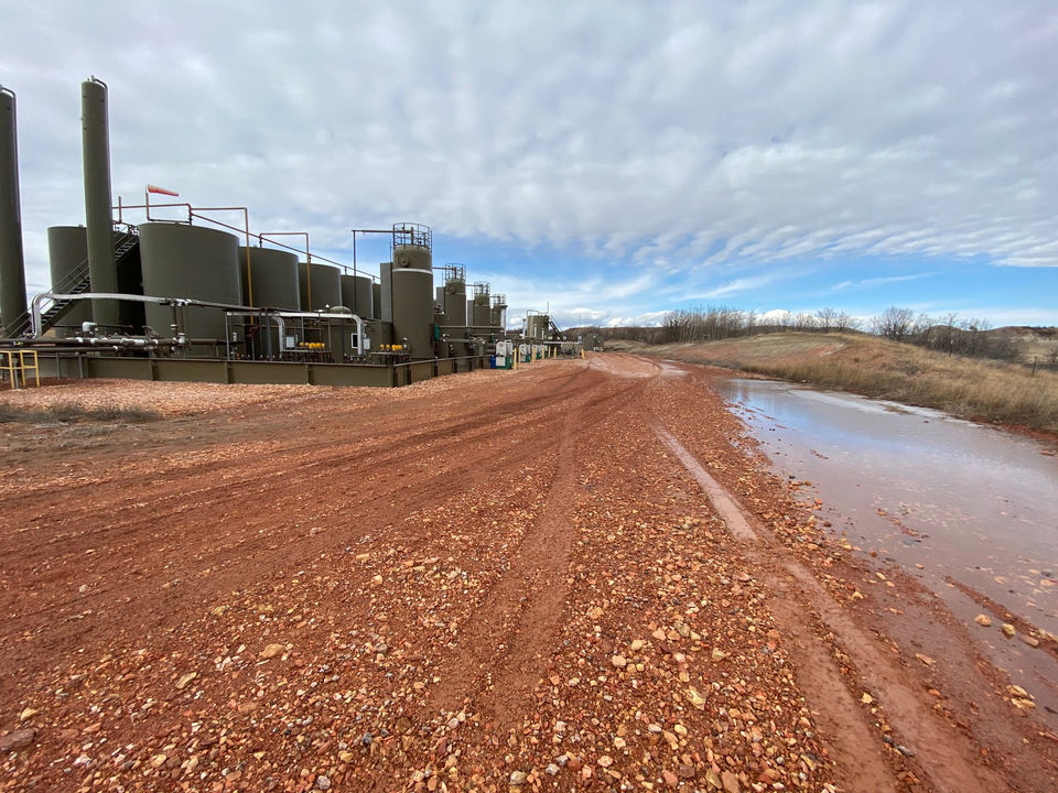 Elite Petro Tech facility: industrial site with processing tanks and red dirt road