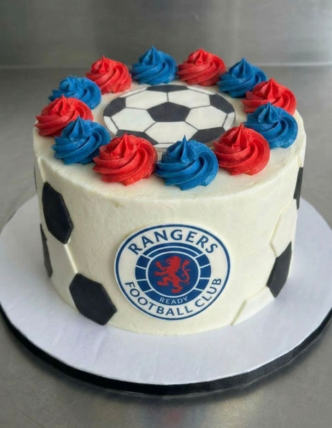 Rangers FC buttercream cake, fondant badge and football topper. red and blue rosette alternate swirls with fondant black and white panelled ball effect sides