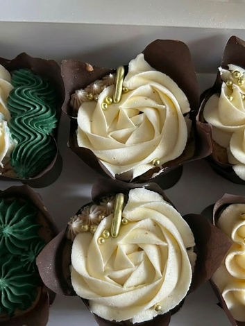 Hand piped green and cream roses and swirls with edible gold sprinkles
