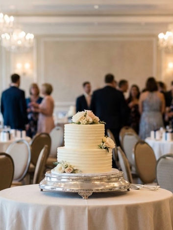 Buttercream wedding cake with detailed sides, flower detail