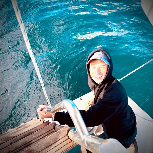 Sudent on a boat looking happy