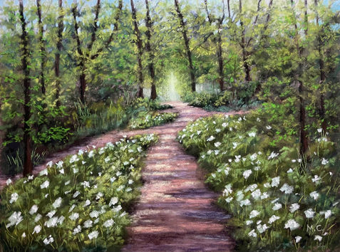 The image of a woodland with a long path ending with bright light and wild garlic flowers blooming on the path