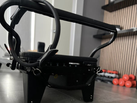 Reformer pilates machine reflected on the mirror with its ring pilates