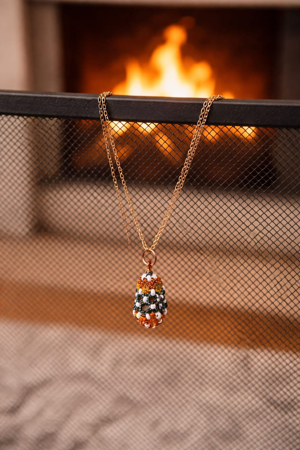 Thumbnail: Handmade orange, grey, and white beaded pendant on gold chain necklace