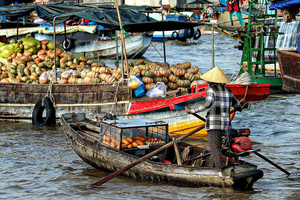 Eye-level view of a traditional wooden boat cruising on the Mekong River