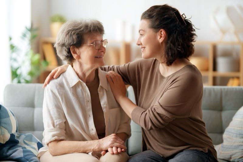 A family member comforting and providing caregiving services to a transplant recipient at home.
