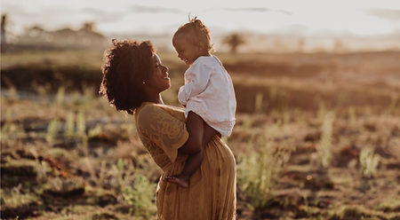 Pregnant mom holding infant baby