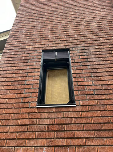 Black Fire Shutter installed on brick in the Glebe Ottawa, Ontario