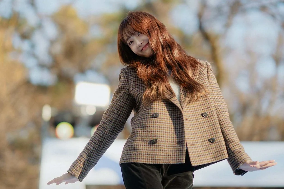 Kim Hye Jun as Nam Da Reum in My Bias, My Boss K-drama still with bangs and red hair in a plaid jacket