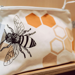 A Manchester bee fabric make up bag.
