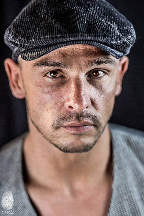 a close up of a man 's face wearing a hat