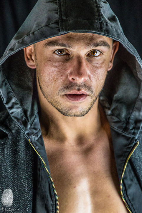 a close up of a man wearing a hooded jacket