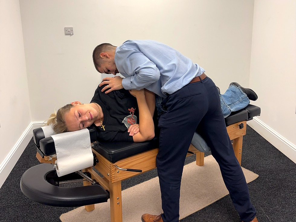 Chiropractor in Aston Clinton adjusting a patient's lower back.