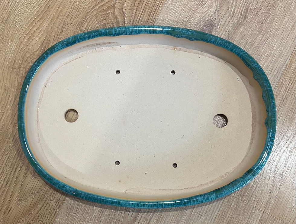 Thumbnail: Handmade shallow round pot with a glossy green glaze