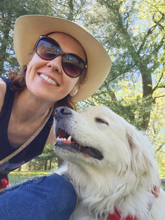 A woman is posing for a picture with her dog.